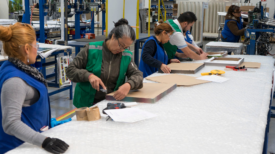 Wholesale production team packaging limited-edition art prints at Art Brand Studios facility – Frequently Asked Wholesale Art Questions.